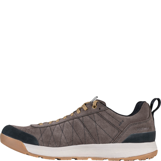 Brown sneaker with black and white sole on a white background