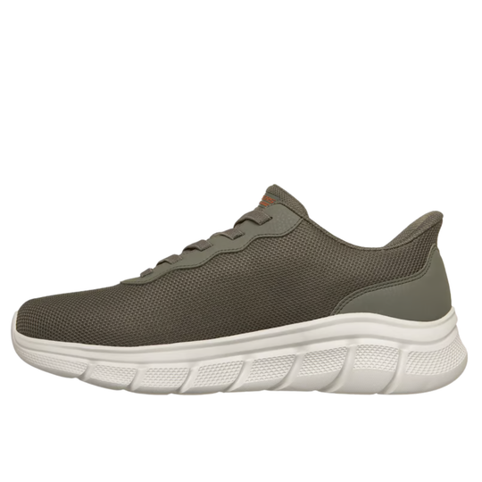 green athletic shoe with white sole on a white background