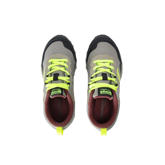 Pair of gray running shoes with neon yellow laces on a white background