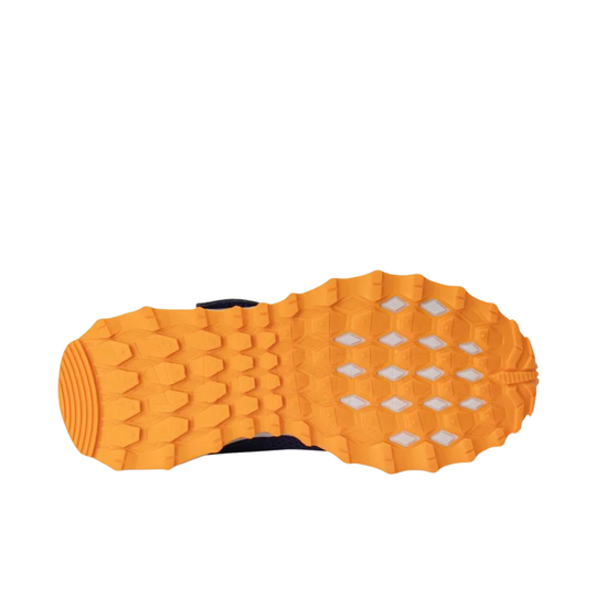 Close-up of an orange shoe sole with textured pattern on a white background