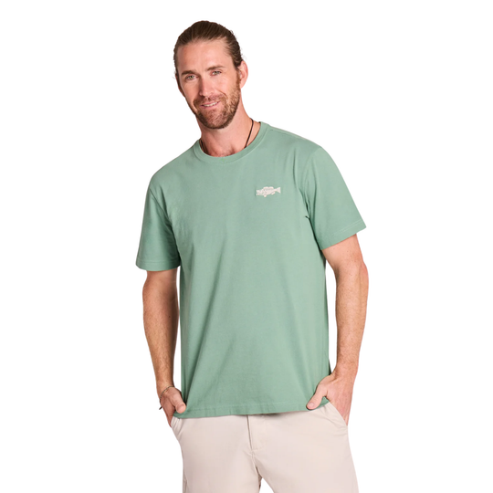 Man wearing a green t-shirt with a logo on a white background