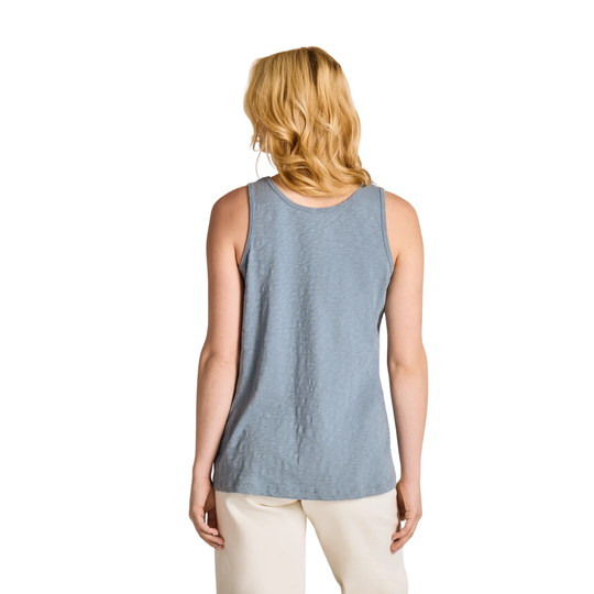 Woman wearing a sleeveless blue top on a white background