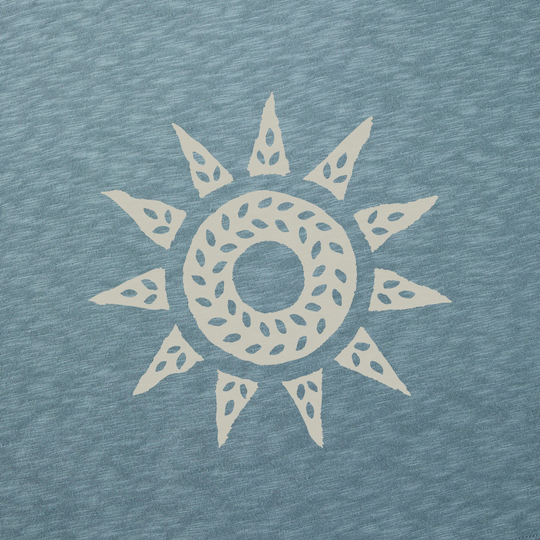 Decorative sun design on a textured blue fabric background