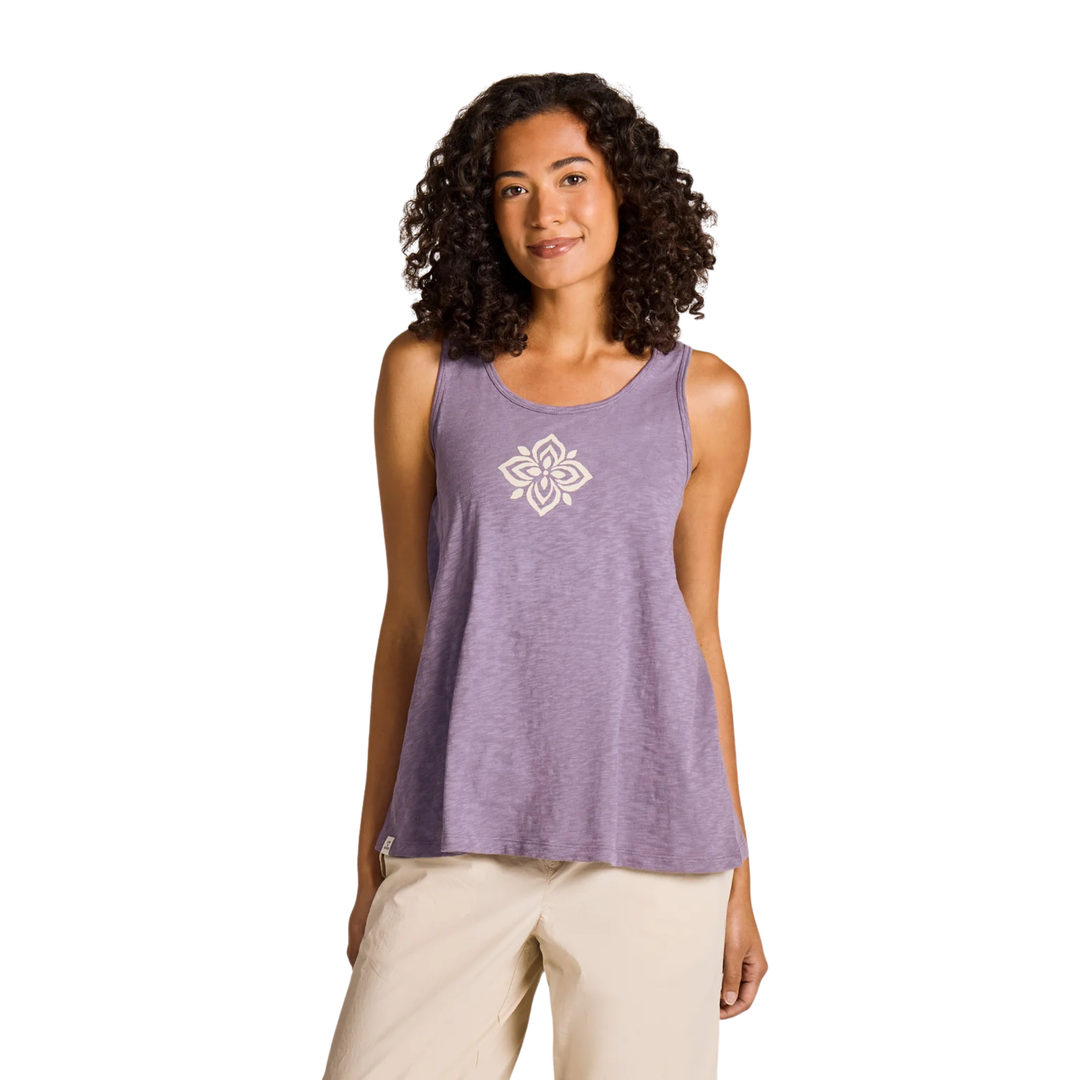Woman wearing a purple tank top with a white floral design on a white background