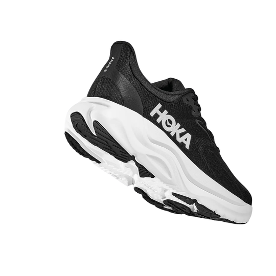 Black running shoe with white sole on a white background
