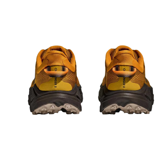 Rear view of two mustard yellow and dark brown trail shoes with thick lugged soles