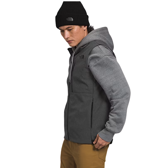 Person wearing a gray hoodie with a black beanie and brown pants on a white background