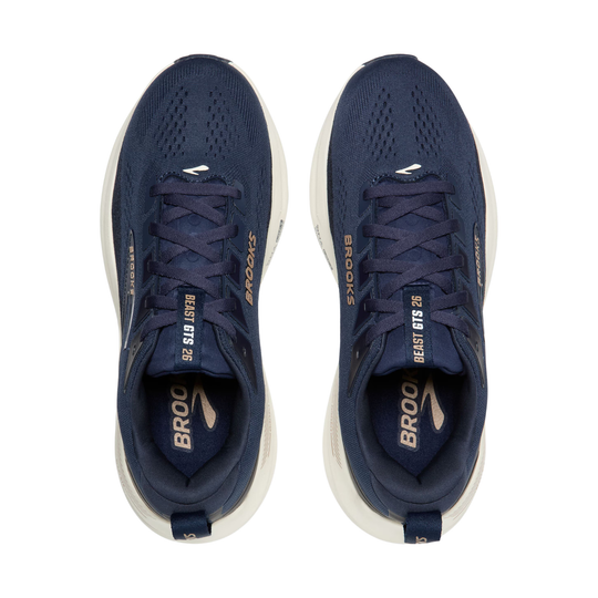 Pair of navy running shoes with white soles on a white background