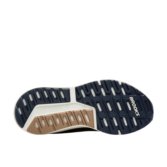 Running shoe outsole with navy, tan, and white traction pads and Brooks branding