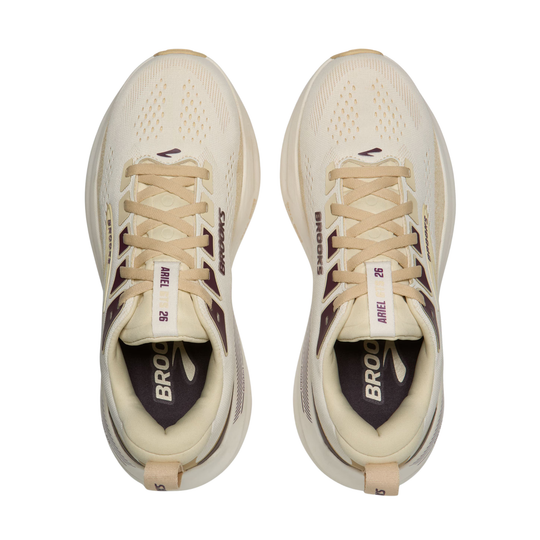 Pair of beige running shoes with visible branding on a white background