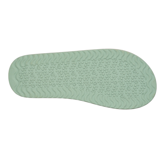 Green shoe sole with textured surface on a white background
