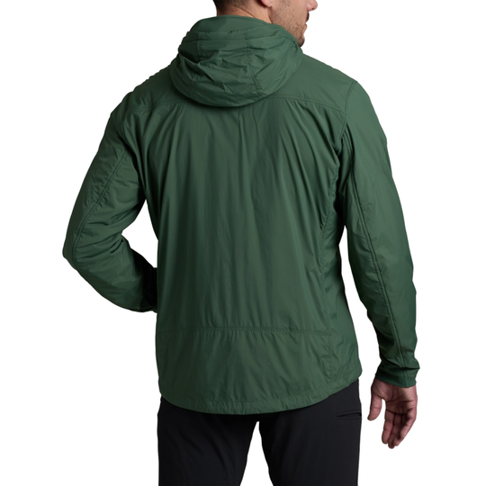 Green jacket worn by a person on a beige background