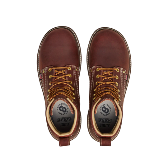 Pair of brown leather boots with laces on a white background