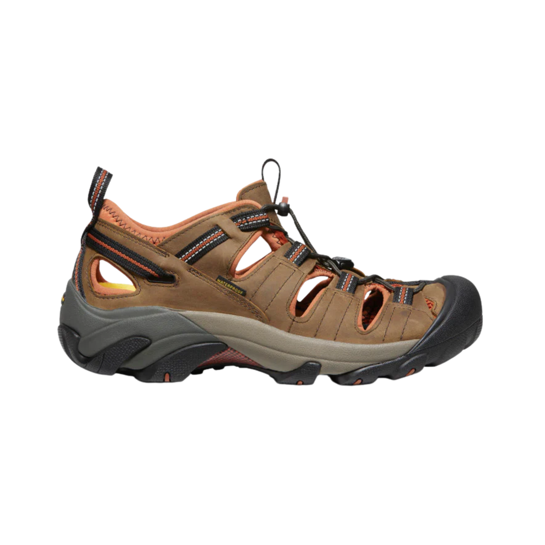 Brown hiking sandal with black sole on a white background