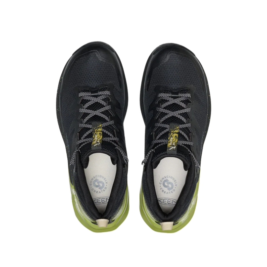 Black athletic shoes with green soles on a white background