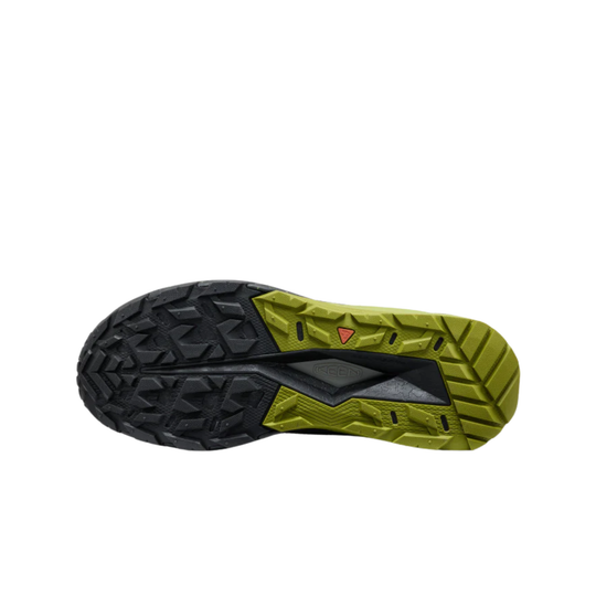 Close-up of a black and green sole with tread pattern on a white background