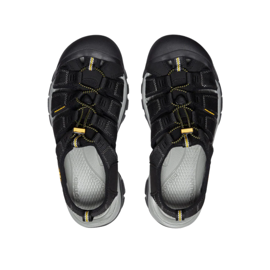 Black and gray sandals with yellow accents on a white background