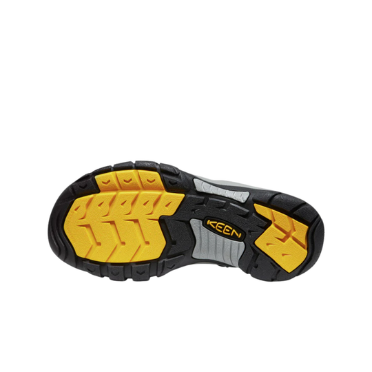 Close-up of a shoe sole with yellow and black tread pattern on a white background