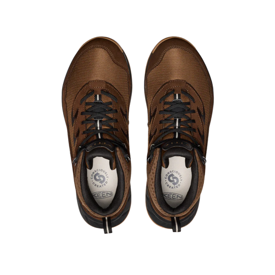 Pair of brown sneakers with black laces on a white background