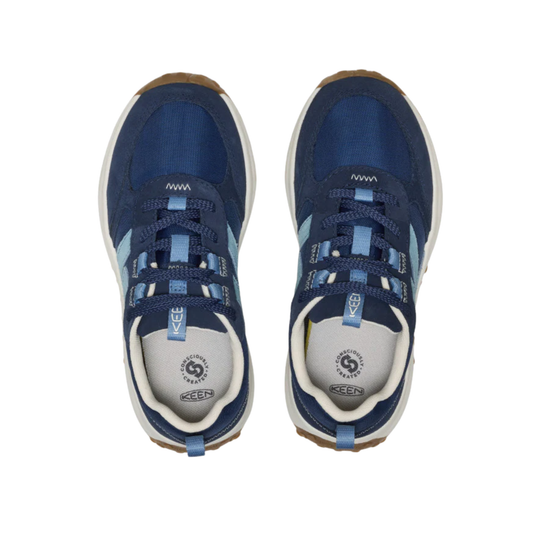 Pair of blue sneakers with white soles on a white background