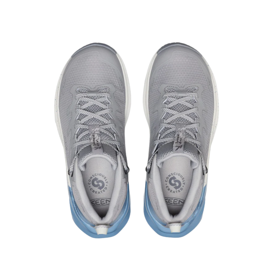 Pair of gray athletic shoes with blue soles on a white background