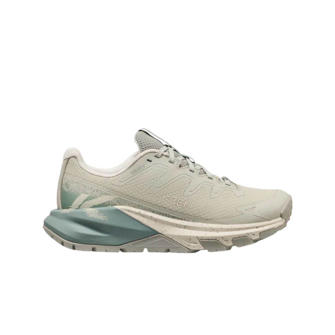 Light gray running shoe with a green sole on a white background