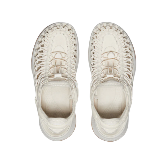 Pair of white woven sneakers on a white background