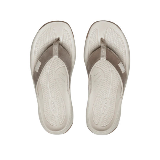Pair of beige flip-flops on a white background