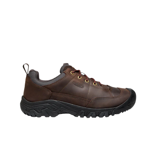 Brown leather shoe with black sole on a white background