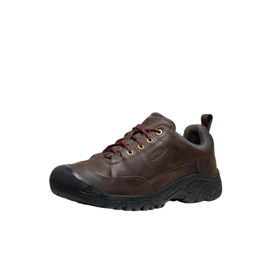 Brown leather shoe with black sole on a white background