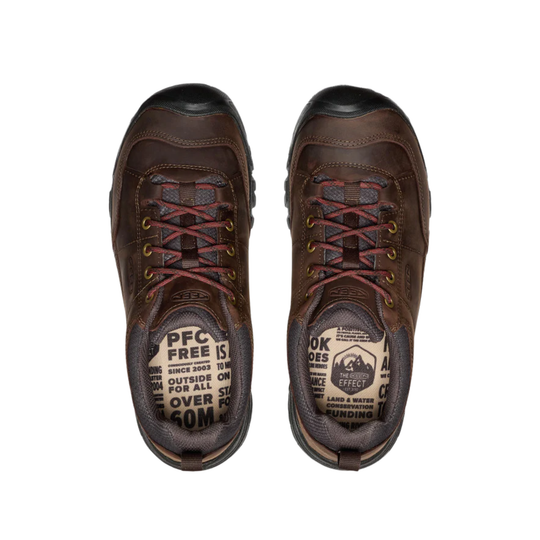 Pair of brown hiking boots with visible branding on a white background