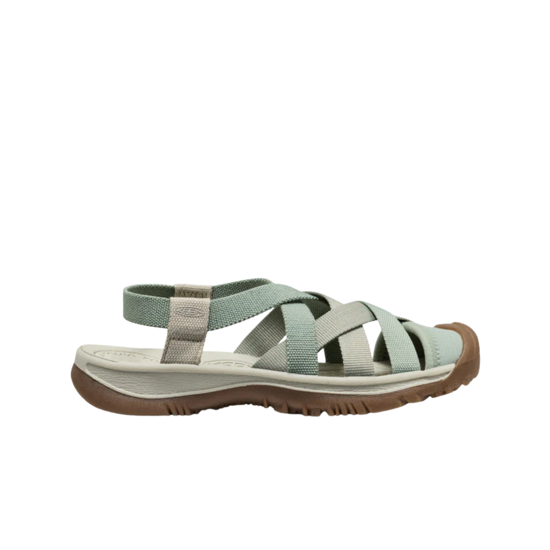 Light green sandal with brown sole on a white background