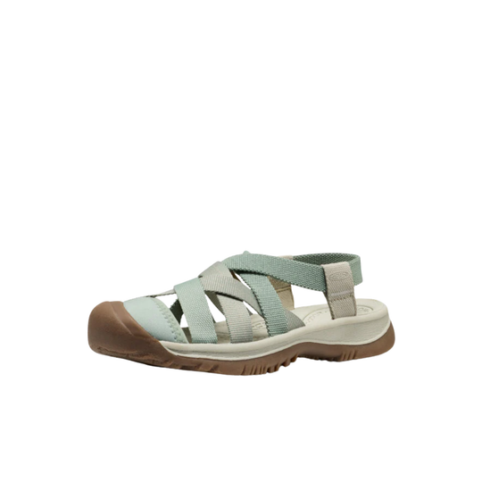 Light green sandal with brown sole on a white background