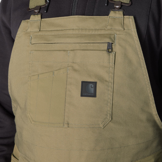 Close-up of a green apron with a visible brand logo on a black background