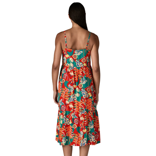 Woman wearing a colorful floral dress on a white background