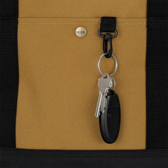 Keychain with keys attached to a mustard yellow fabric surface