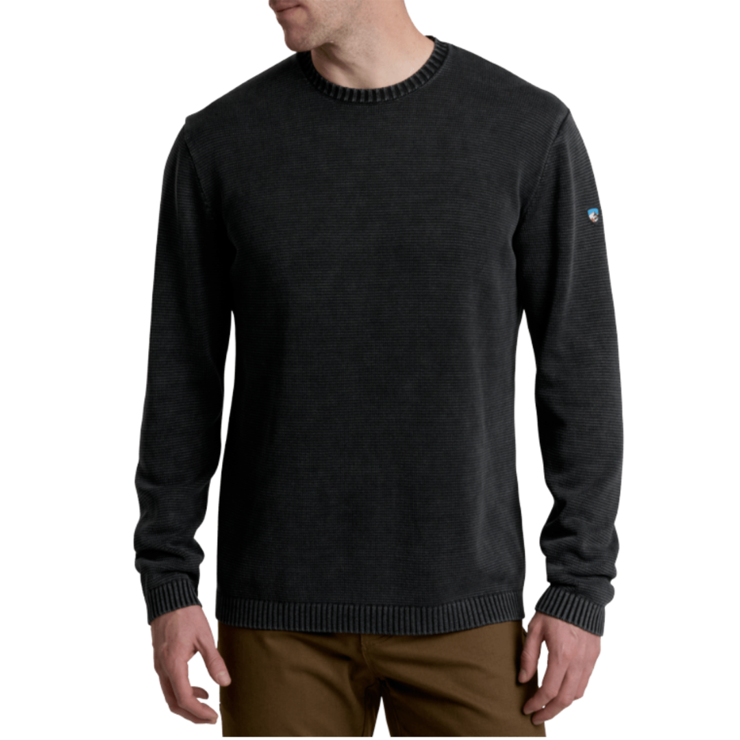 Black sweater worn by a person on a white background