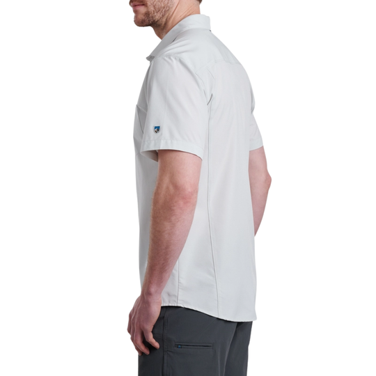 Man wearing a grey short-sleeve shirt with a brand logo on a white background