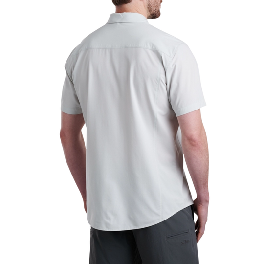 Man wearing a light gray short-sleeve shirt on a white background