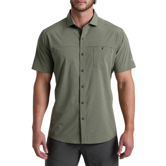 Man wearing a green short-sleeve button-up shirt on a white background