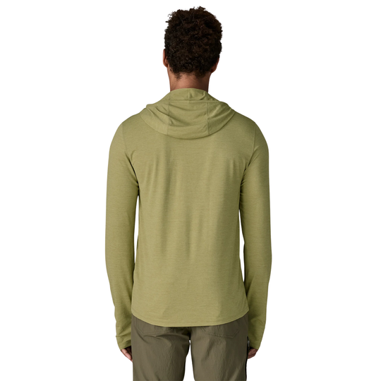 Person wearing a green hoodie from behind on a white background