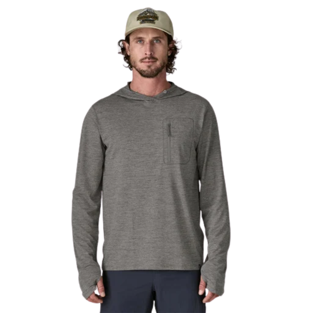Man wearing a gray hoodie and cap on a white background