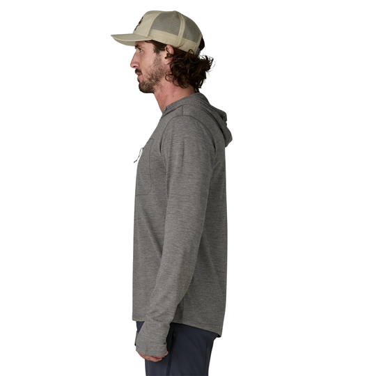 Man wearing a gray hoodie and cap on a white background