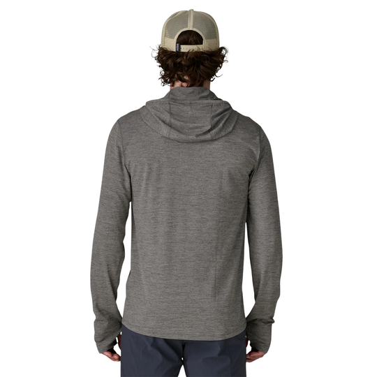 Person wearing a gray hoodie and cap from behind on a white background