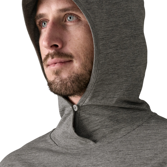 Man wearing a gray hoodie against a white background