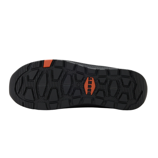 Black and orange sole of a shoe on a white background