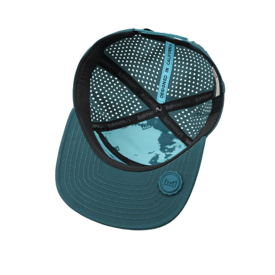 inside of Atlantic blue hat with melin logo on corner behind white background 