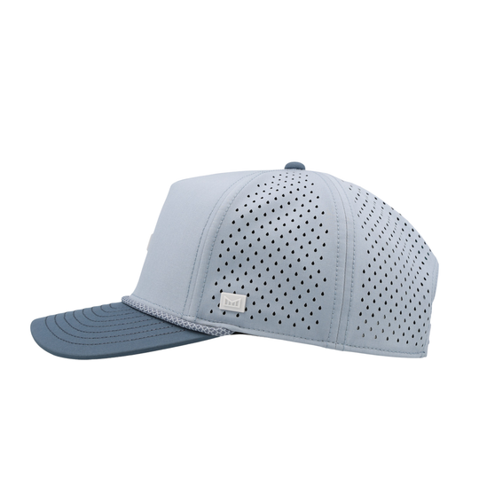 Light blue baseball cap with perforated design on a white background