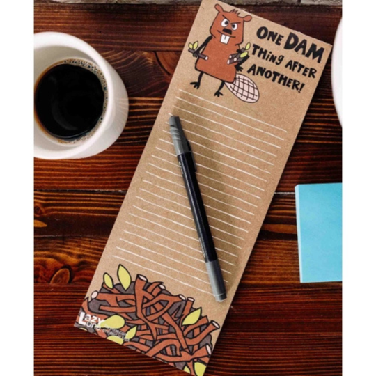 Notebook with cartoon groundhog design and text on a wooden surface with a cup of coffee.