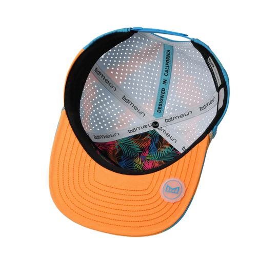 Orange cap with a colorful floral pattern on the visor against a white background